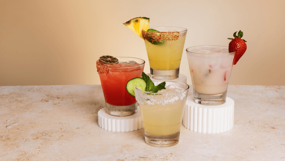 Dreamy background image of Pinstripes May LTO margaritas including Garden Glow, Spring Fling, Desert Bloom, and Hot Pants