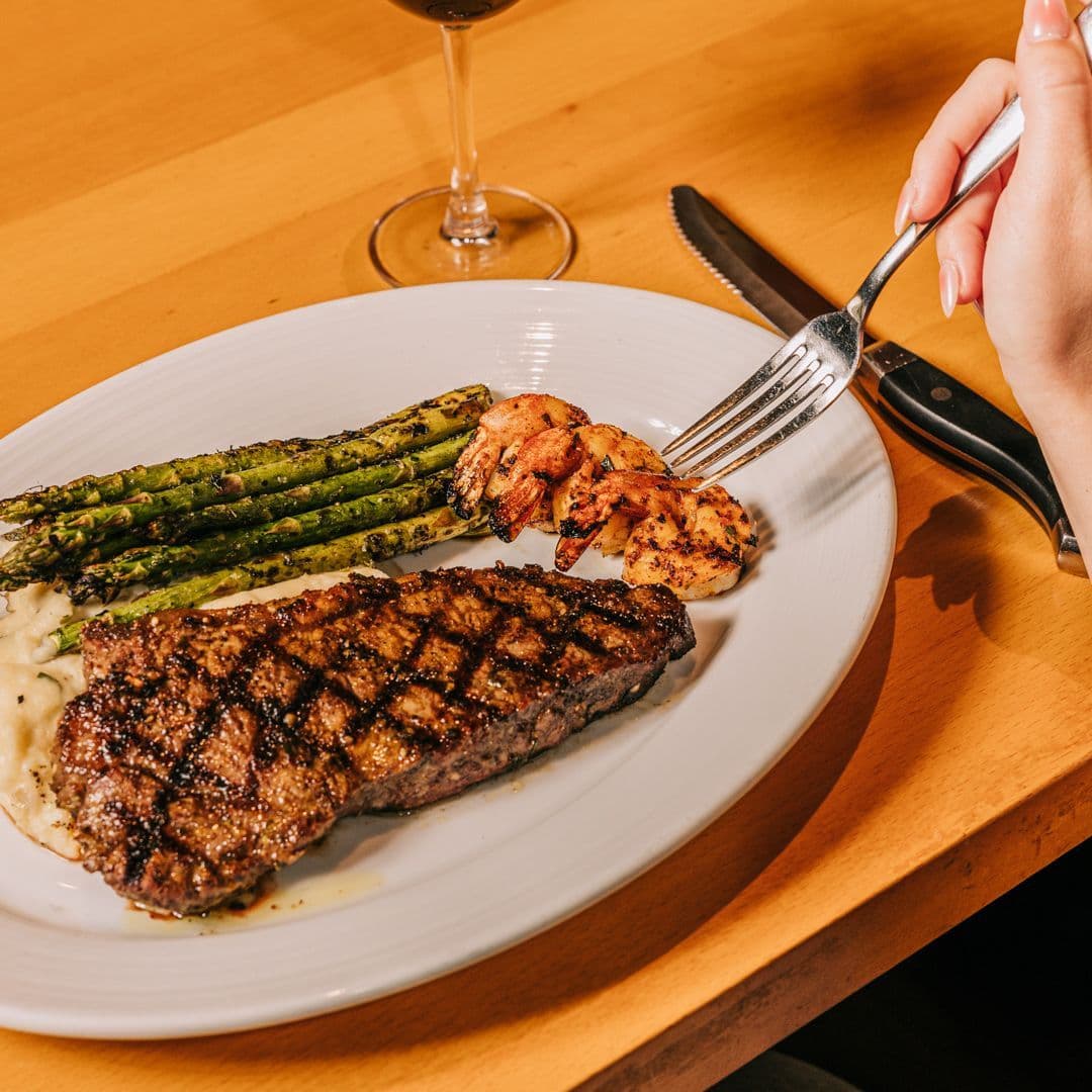 New York strip steak with grilled shrimp and asparagus for Friday special