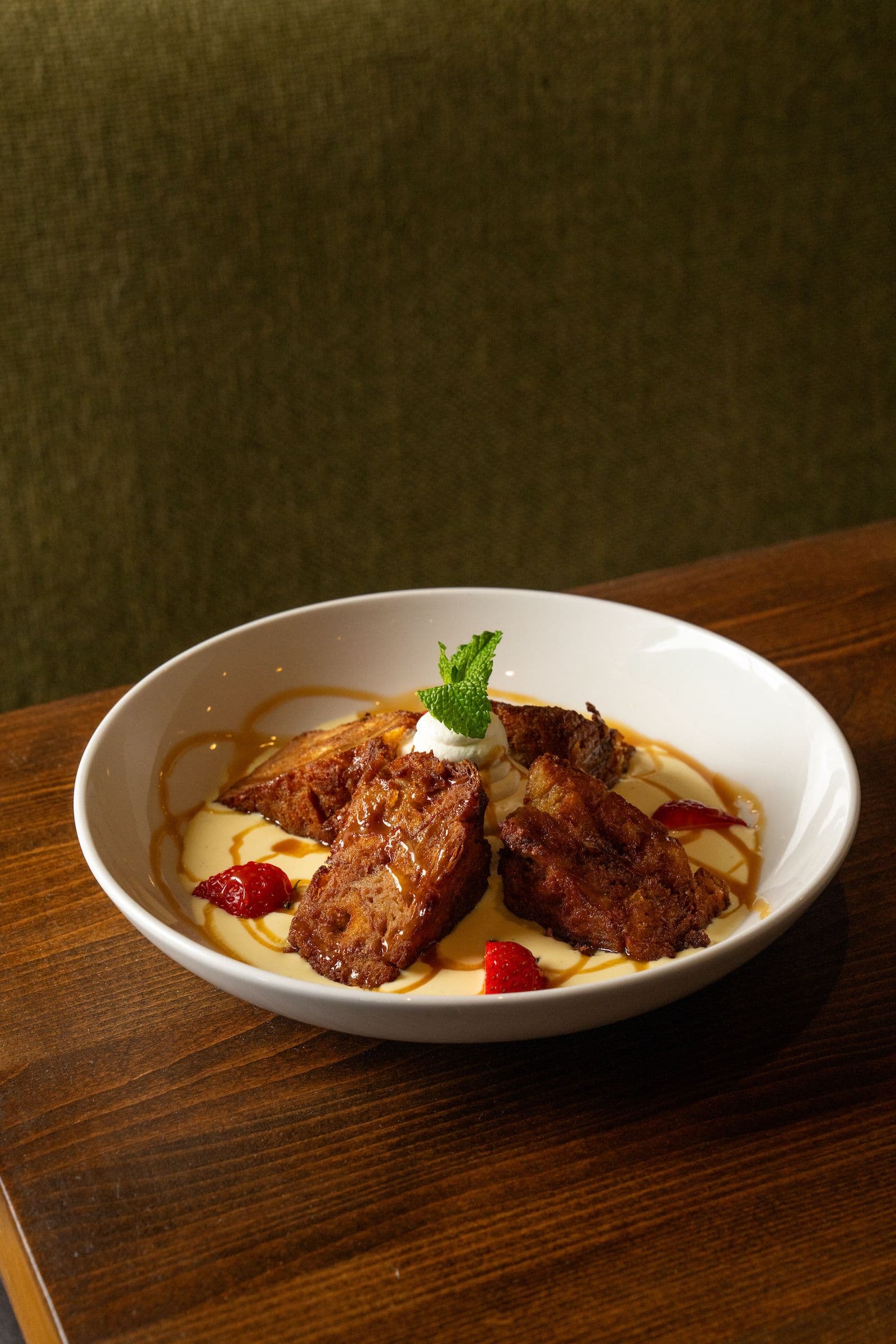 Close-up of Pinstripes Apple Bread Pudding dessert.