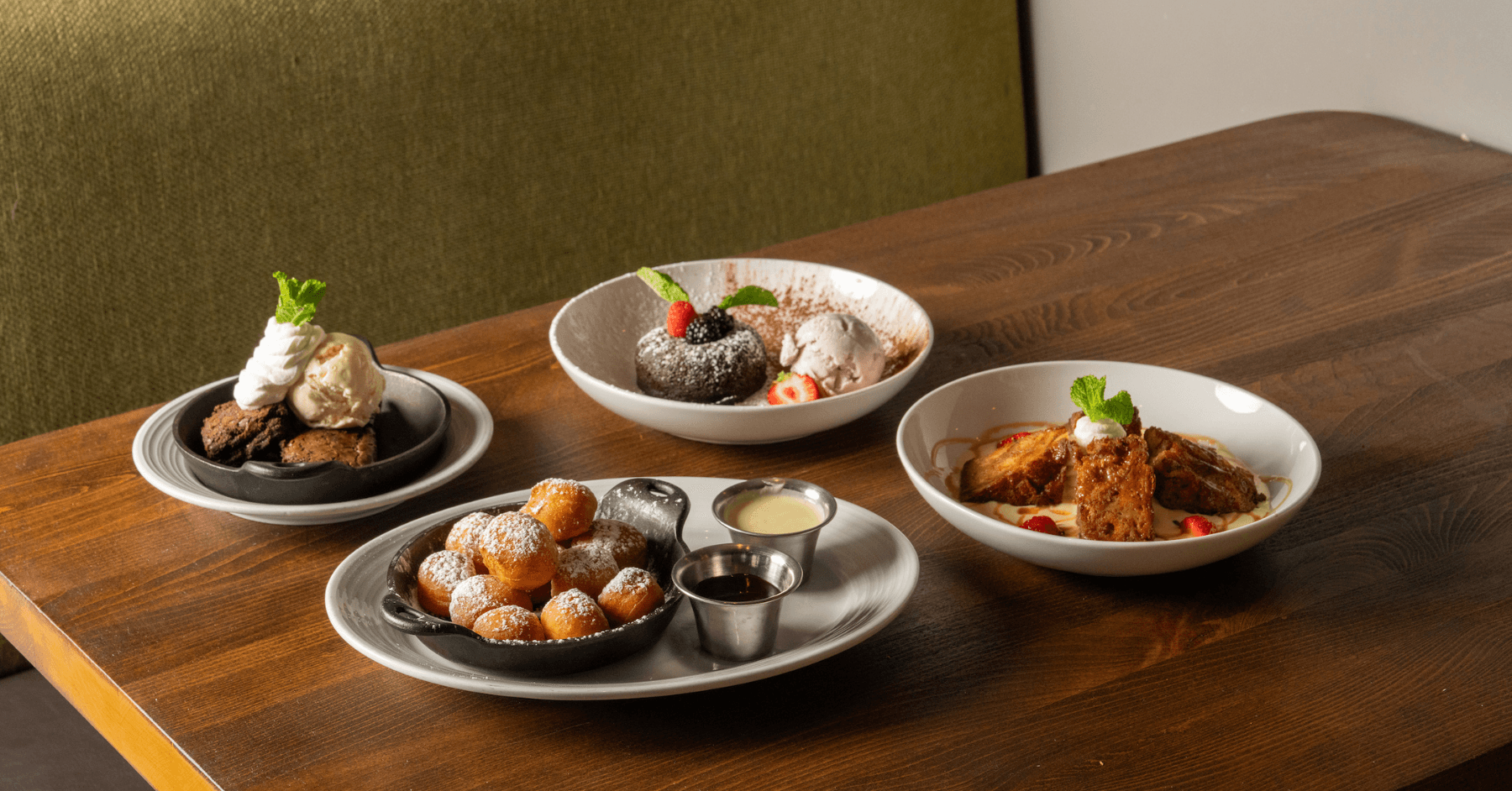 Sweet Donut Bites, Apple Bread Pudding, Chocolate Lava Cake, brownie and ice cream arranged together.